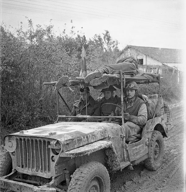 An RCAMC jeep ambulance carrying two wounded Canadian soldiers on the Moro River front near San Leonardo di Ortona, Italy, December 1943