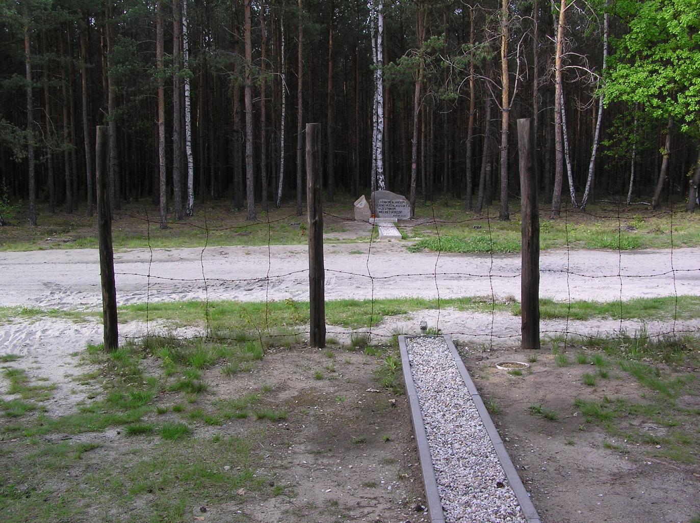 The entrance shaft of tunnel Harry at Stalag Luft III, showing the wood-framed opening beneath a stove in the barracks